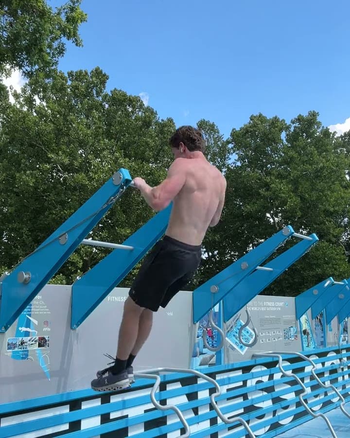 Athlete leaning over the bar as the wrists rotate on top